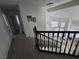 Staircase with wood banister, leading to the first floor with decorative lights and tiled floors at 8401 Luna Bay Ln, Las Vegas, NV 89128