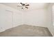 This bright bedroom features carpet floors and a ceiling fan at 8515 Belcastro St, Las Vegas, NV 89113