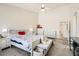 Comfortable bedroom features a bed with floral bedding, vaulted ceiling, and lots of light at 8515 Belcastro St, Las Vegas, NV 89113
