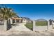 Home featuring secure gated entrance, well-kept lawn and efficient solar panels at 8515 Belcastro St, Las Vegas, NV 89113
