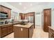 Well-lit kitchen features wood cabinets, granite counters, and a stainless steel refrigerator at 8515 Belcastro St, Las Vegas, NV 89113
