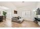 Bright living room with hardwood floors, natural light, and comfortable seating at 8515 Belcastro St, Las Vegas, NV 89113