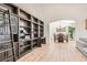 Bright living room with high ceilings, custom built-in bookshelves, and wood-look flooring at 8515 Belcastro St, Las Vegas, NV 89113