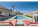 Enjoy the view of the sparkling pool from the covered outdoor living space and lounge chairs at 8515 Belcastro St, Las Vegas, NV 89113