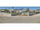 Wide view of this beautiful single-story home featuring a gated entrance and solar panels at 8515 Belcastro St, Las Vegas, NV 89113