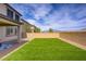 Expansive backyard with artificial turf and gravel landscaping, complemented by mountain views in the distance at 8564 Scalpay St, Las Vegas, NV 89166