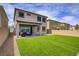 Relax in this backyard with a covered patio, easy-care artificial turf, and stylish pavers at 8564 Scalpay St, Las Vegas, NV 89166
