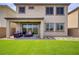 Inviting backyard with lush artificial turf, patio seating, and a covered area, ideal for outdoor living at 8564 Scalpay St, Las Vegas, NV 89166