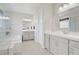 Spacious bathroom with double vanities, a soaking tub, and a glass-enclosed shower at 8564 Scalpay St, Las Vegas, NV 89166