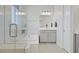 Bathroom featuring a soaking tub, glass shower, and vanity with bright lighting at 8564 Scalpay St, Las Vegas, NV 89166