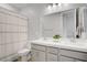 Bathroom showcasing a double sink vanity and tile flooring with a shower curtain at 8564 Scalpay St, Las Vegas, NV 89166