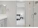 Bright bathroom with a glass shower, vanity, and view to the bedroom at 8564 Scalpay St, Las Vegas, NV 89166