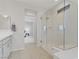Modern bathroom with a glass shower and vanity, offering a view into the bedroom at 8564 Scalpay St, Las Vegas, NV 89166