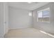 Bright bedroom with neutral carpet and a window offering a neighborhood view at 8564 Scalpay St, Las Vegas, NV 89166