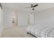 Expansive bedroom with ceiling fan, seamless doorways, and a peek into a pristine bathroom at 8564 Scalpay St, Las Vegas, NV 89166