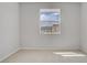 Well-lit bedroom with neutral carpet and a window offering a neighborhood view at 8564 Scalpay St, Las Vegas, NV 89166