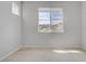 Well-lit bedroom with neutral carpet and a window offering a neighborhood view at 8564 Scalpay St, Las Vegas, NV 89166