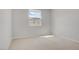 Bright bedroom featuring neutral carpet and walls with a window view at 8564 Scalpay St, Las Vegas, NV 89166