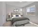 Staged bedroom with contemporary furnishings and plenty of natural light from the window at 8564 Scalpay St, Las Vegas, NV 89166