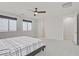 Spacious bedroom with three windows offering scenic views, and a ceiling fan providing comfort at 8564 Scalpay St, Las Vegas, NV 89166