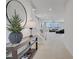 Bright entryway featuring a console table with decor, staircase, and open view to living area at 8564 Scalpay St, Las Vegas, NV 89166