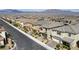Community street view displays multiple homes with neatly landscaped yards and mountain views in the background at 8564 Scalpay St, Las Vegas, NV 89166