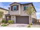 Charming two-story home with stucco facade, stone accents, a two-car garage, and professionally landscaped front yard at 8564 Scalpay St, Las Vegas, NV 89166