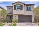Charming two-story home with stucco facade, stone accents, a two-car garage, and professionally landscaped front yard at 8564 Scalpay St, Las Vegas, NV 89166