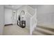 Bright foyer with decoratively placed mirror and decorative table leading to living room with staircase on the right at 8564 Scalpay St, Las Vegas, NV 89166