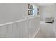 Upstairs hallway features white railing, carpeted floor, and natural light at 8564 Scalpay St, Las Vegas, NV 89166
