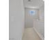 Hallway with neutral walls, neutral carpet and a white railing at 8564 Scalpay St, Las Vegas, NV 89166