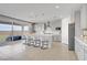 Eat-in kitchen features a spacious island with seating and sliding door access to patio at 8564 Scalpay St, Las Vegas, NV 89166