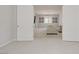 Spacious open-plan living room with neutral tones and access through white double doors at 8564 Scalpay St, Las Vegas, NV 89166