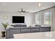 Comfortable living room features a large gray sofa and a modern ceiling fan at 8564 Scalpay St, Las Vegas, NV 89166