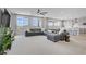 Bright living room featuring a comfortable gray sectional and large windows with natural light at 8564 Scalpay St, Las Vegas, NV 89166
