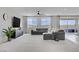 Spacious living room with plush sectional sofa, ceiling fan, and sliding doors to outdoor area at 8564 Scalpay St, Las Vegas, NV 89166