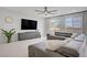 Bright, open living room with large windows and comfortable gray sectional seating at 8564 Scalpay St, Las Vegas, NV 89166