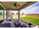 Covered patio with comfortable seating overlooking artificial turf, offering an inviting outdoor living space at 8564 Scalpay St, Las Vegas, NV 89166
