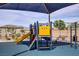 Community playground featuring a slide, climbing structure, and shade structure for sunny days at 8564 Scalpay St, Las Vegas, NV 89166