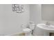 Modern powder room with pedestal sink, tiled floor, and decorative wall art at 8564 Scalpay St, Las Vegas, NV 89166
