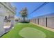 Enjoy the backyard artificial turf putting green alongside a covered dining area and relaxing fire pit at 8725 Hawk Canyon St, Henderson, NV 89074