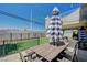 Patio area with a table and chairs set on artificial grass, perfect for relaxing at 8725 Hawk Canyon St, Henderson, NV 89074