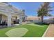 The home boasts a backyard with artificial turf, putting green, BBQ, shaded dining, and relaxation spaces at 8725 Hawk Canyon St, Henderson, NV 89074