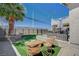 Enjoy the artificial turf lawn, backyard fire pit and seating, along with a shaded patio and putting green at 8725 Hawk Canyon St, Henderson, NV 89074