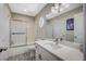 Bright bathroom featuring a shower-tub combo, modern vanity and stylish lighting at 8725 Hawk Canyon St, Henderson, NV 89074