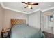 Cozy bedroom with neutral walls, ceiling fan, and an upholstered headboard at 8725 Hawk Canyon St, Henderson, NV 89074
