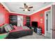 Cozy bedroom with striking red accent wall, shelving, and a comfortable bed at 8725 Hawk Canyon St, Henderson, NV 89074