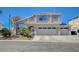 Charming two-story home with well-maintained landscaping, arched entry, and a three-car garage at 8725 Hawk Canyon St, Henderson, NV 89074