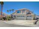 Two-story home with a three-car garage, well-maintained landscaping, and modern design at 8725 Hawk Canyon St, Henderson, NV 89074