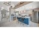 This open concept kitchen has an island with bar seating, gray cabinets, and stainless steel appliances at 8725 Hawk Canyon St, Henderson, NV 89074